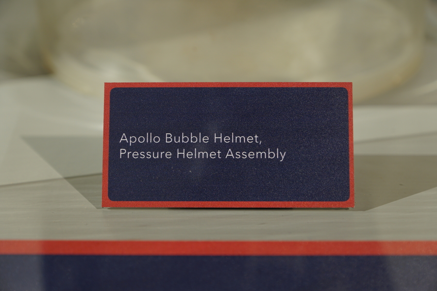 Sign accompanying the Apollo A7L/A7LB Pressure Helmet Assembly ("Bubble Helmet") at Apollo:  When We Went to the Moon