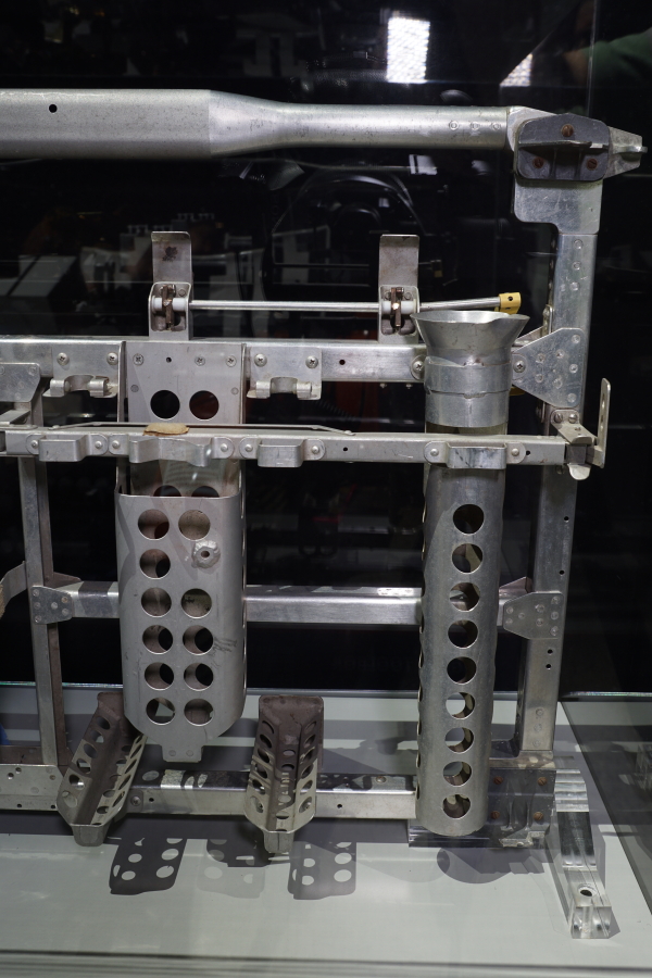 Hinge ear brackets; retainers for extension handle, adjustable sampling scoop, tongs, and soil sampler; and rod for sample collection bag on Lunar Hand Tool Carrier at Apollo:  When We Went to the Moon