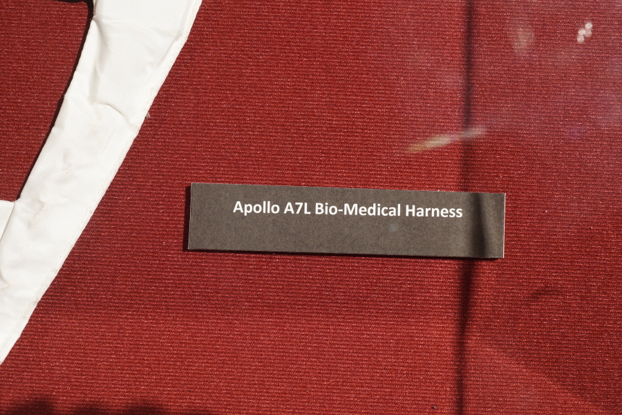 Sign accompanying the A7L Suit Bio-Medical Harness at Celebrating Apollo