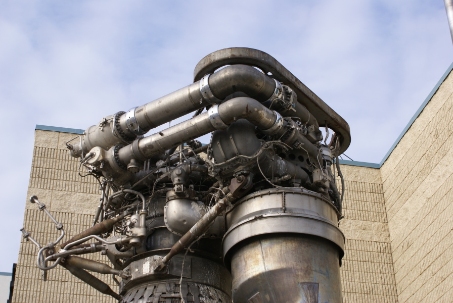 Forward end of F-1 Engine at Kansas Cosmosphere, including interface panel, fuel inlet elbows, turbopumps, LOX high-pressure duct, and fuel (RP-1) high-pressure-duct