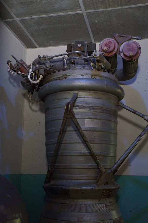 Forward end of LR-89 (Atlas Booster) Engine, including combustion chamber, propellant (LOX/RP-1) high-pressure lines, hypergol manifold, and gimbal actuator outrigger at Kansas Cosmosphere