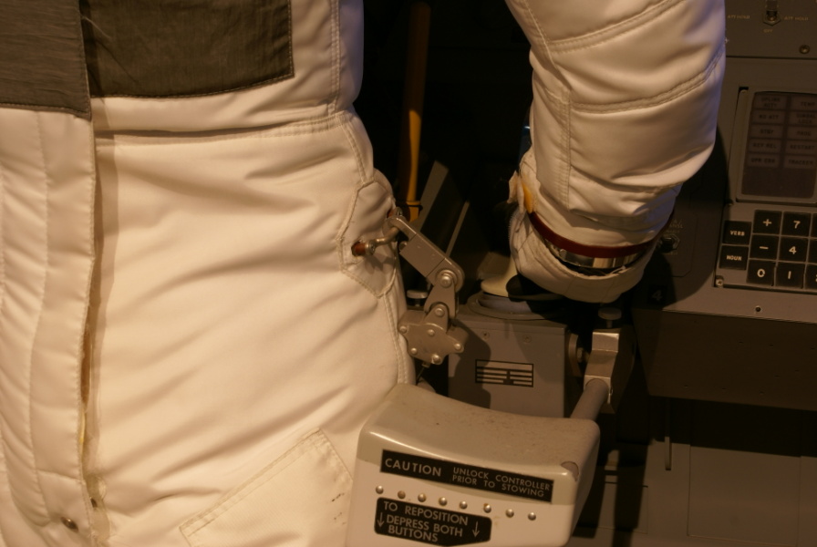 Lunar Module (LM) restraint system, including cables and PGA waist restraint rings. Hand controller armrest is also visible. In the LM Cockpit Mockup at the Cradle of Aviation.