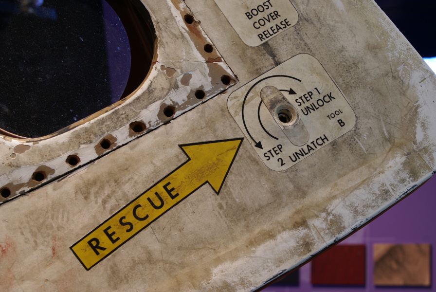 Hole for hatch opening tool and rescue decal on SL-3 (Skylab 2) hatch exterior at Great Lakes Science Center