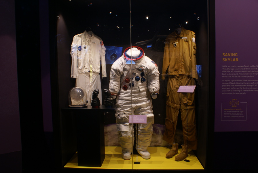 Aldrin's Apollo 11 inflight coverall garment (ICG), Paul Weitz's SL-2 (Skylab 1) space suit, and Lousma's SL-3 (Skylab 2) flight suit