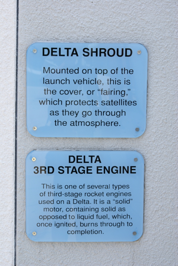 Signs accompanying the Delta Payload Fairing/Shroud at Goddard Space Flight Center
