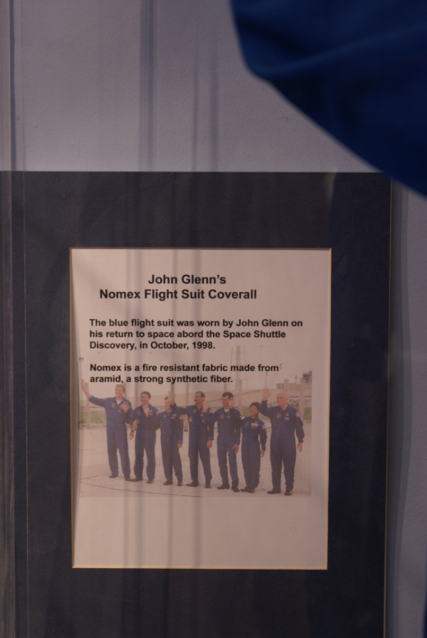 Sign accompanying John Glenn's STS-95 flight suit coverall in Glenn Research Center visitor center lobby
