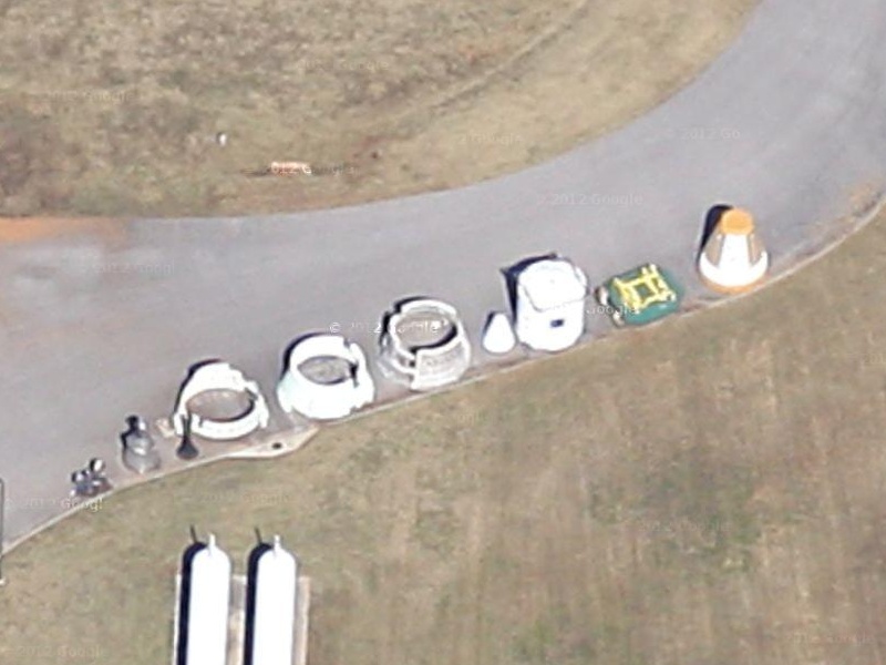 Shuttle Solid Rocket Booster (SRB) parts behind Marshall Space Flight
	Center (MSFC) Building 4205, including aft skirt, forward skirt,
	frustum, and nose cap