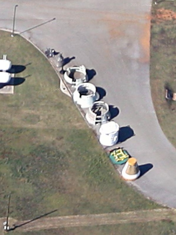 Shuttle Solid Rocket Booster (SRB) parts behind Marshall Space Flight
	Center (MSFC) Building 4205, including aft skirt, forward skirt,
	frustum, and nose cap