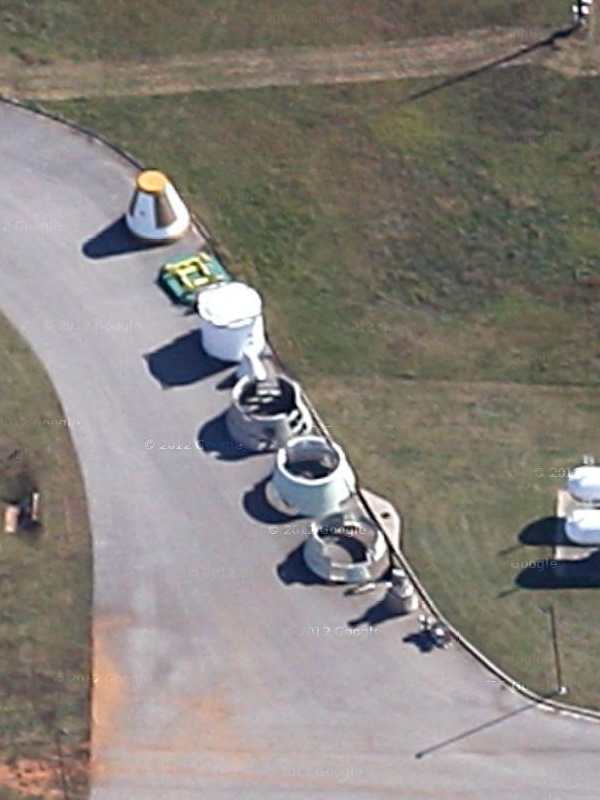 Shuttle Solid Rocket Booster (SRB) parts behind Marshall Space Flight
	Center (MSFC) Building 4205, including aft skirt, forward skirt,
	frustum, and nose cap