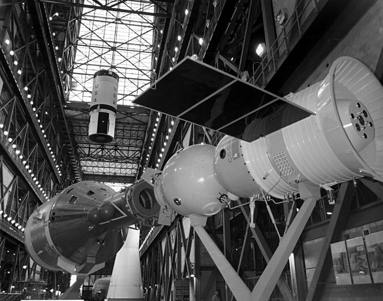 Apollo-Soyuz Test Project (ASTP) mockup in the Vehicle Assembly
	Building (VAB) with astronaut and cosmonaut crews (NASA photo
	KSC-75P-5