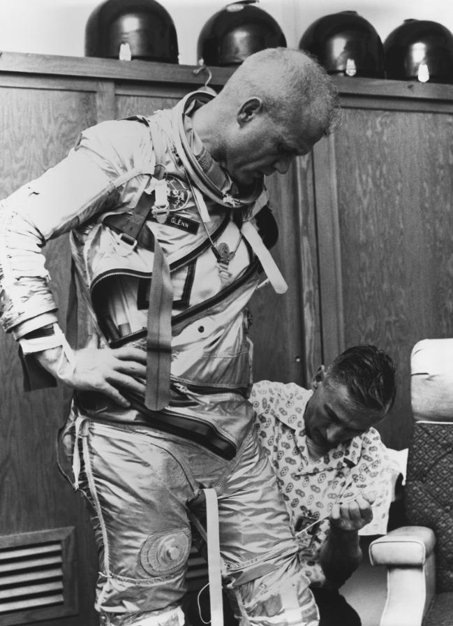 Astronaut John Glenn donning his Project Mercury space suit