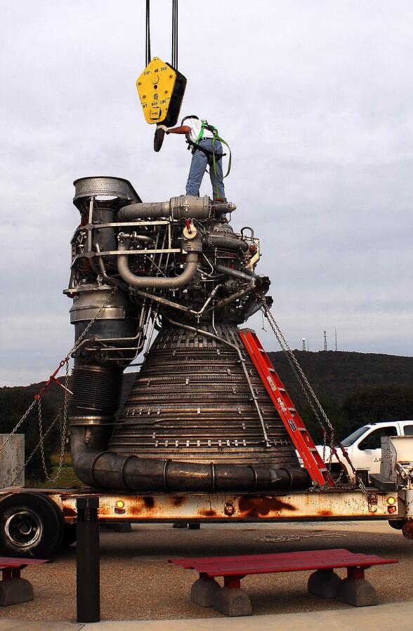 Attaching crane hoist cable to F-1 rocket engine thrust chamber during F-4023 Installation at Building 4205 (October 21, 2009) at Marshall Space Flight Center Engine Displays