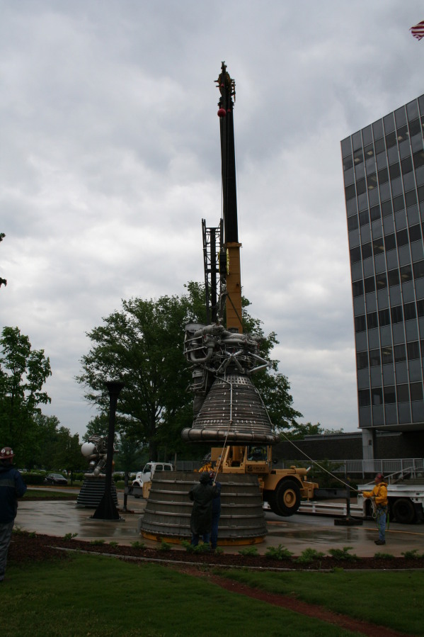 Placing F-1 rocket engine thrust chamber on nozzle extension during Installation of Building 4200 Engines (May 13, 2008) at Marshall Space Flight Center Engine Displays