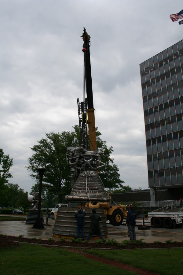 Placing F-1 rocket engine thrust chamber on nozzle extension during Installation of Building 4200 Engines (May 13, 2008) at Marshall Space Flight Center Engine Displays