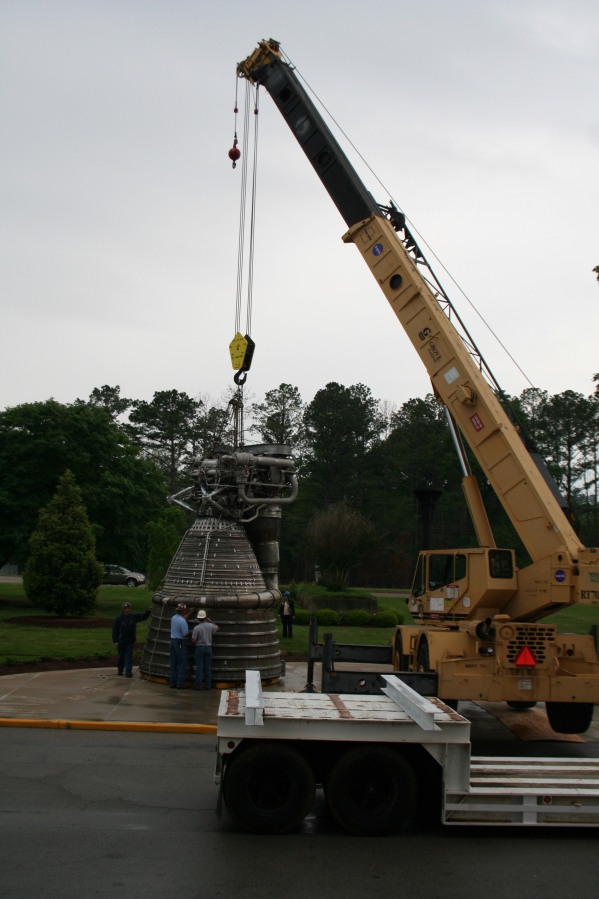 Placing F-1 rocket engine thrust chamber on nozzle extension during Installation of Building 4200 Engines (May 13, 2008) at Marshall Space Flight Center Engine Displays