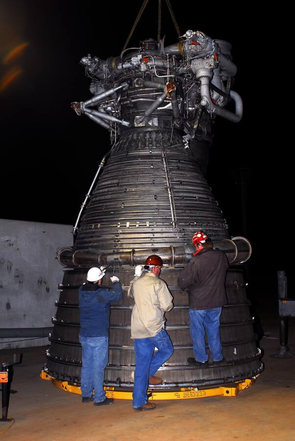 Lifting the F-1 rocket engine thrust chamber onto the nozzle extension during F-5036 Fit Test (March 6, 2008) at Marshall Space Flight Center Engine Displays