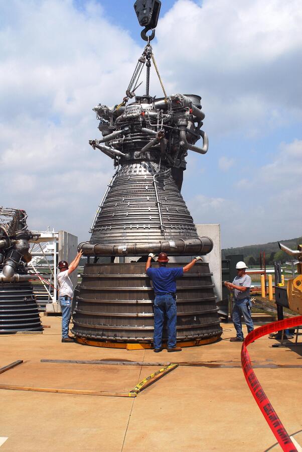 F-1 rocket engine being lowered onto its nozzle extension during F-5036 Fit Test (April 7, 2008) at Marshall Space Flight Center Engine Displays