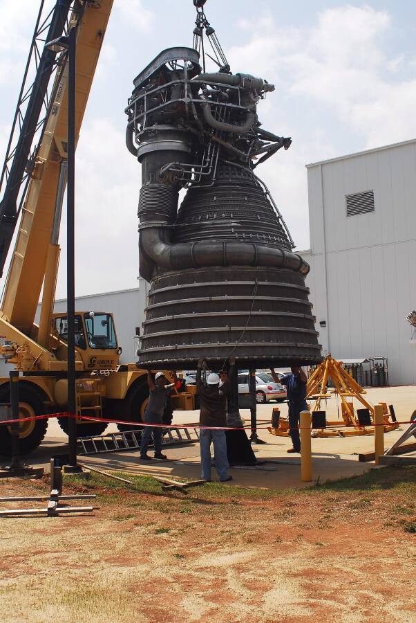 F-1 rocket engine being placed on its throat support during F-5036 Fit Test (April 7, 2008) at Marshall Space Flight Center Engine Displays