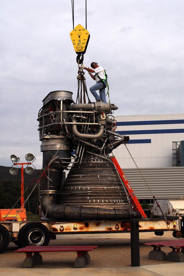 Attaching crane hoist cable to F-1 rocket engine thrust chamber during F-4023 Installation at Building 4205 (October 21, 2009) at Marshall Space Flight Center Engine Displays