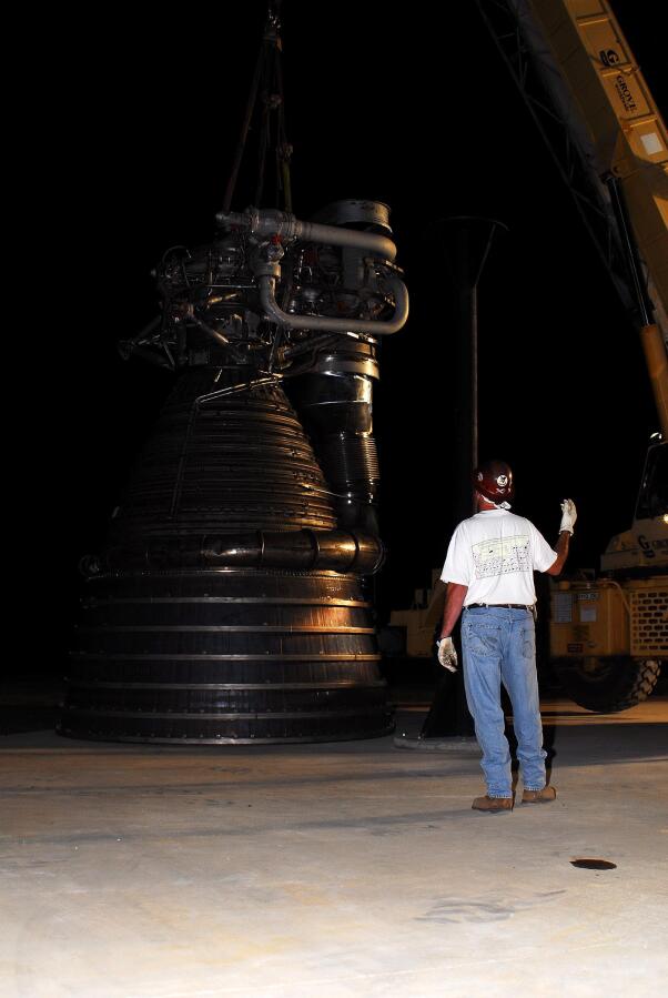 Lifting F-1 rocket engine onto throat support during F-4023 Installation at Building 4205 (October 21, 2009) at Marshall Space Flight Center Engine Displays