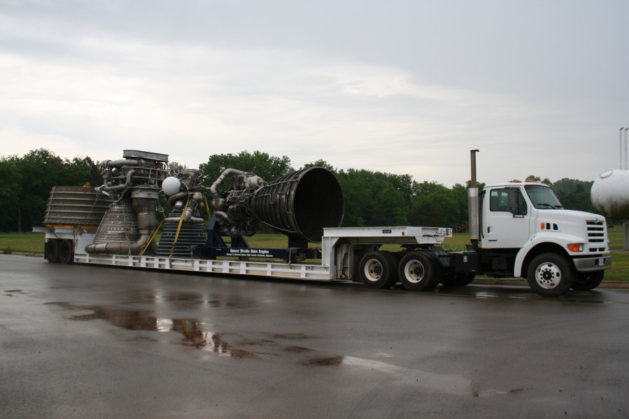 F-1 rocket engine nozzle extension, F-1 rocket engine, J-2 rocket engine, and Space Shuttle Main Engine (SSME) behind Building 4205 during Installation of Building 4200 Engines (May 13, 2008) at Marshall Space Flight Center Engine Displays