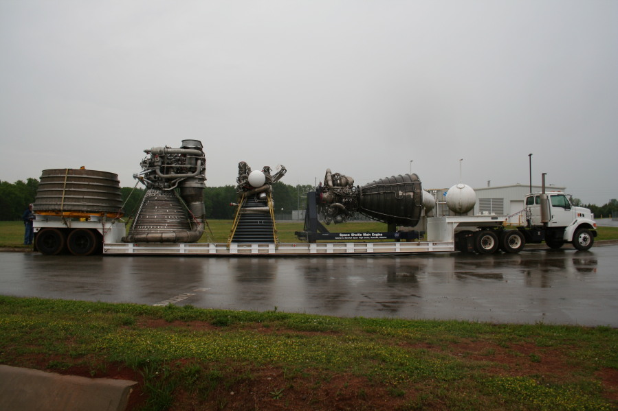 F-1 rocket engine nozzle extension, F-1 rocket engine, J-2 rocket engine, and Space Shuttle Main Engine (SSME) behind Building 4205 during Installation of Building 4200 Engines (May 13, 2008) at Marshall Space Flight Center Engine Displays