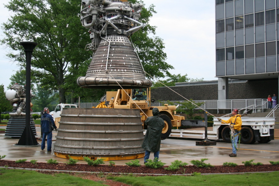 Placing F-1 rocket engine thrust chamber on nozzle extension during Installation of Building 4200 Engines (May 13, 2008) at Marshall Space Flight Center Engine Displays
