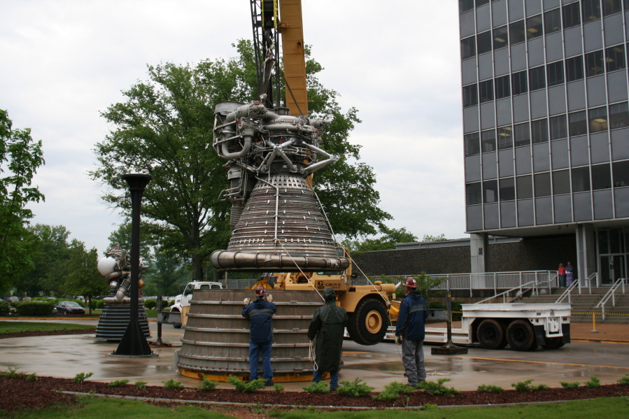 Placing F-1 rocket engine thrust chamber on nozzle extension during Installation of Building 4200 Engines (May 13, 2008) at Marshall Space Flight Center Engine Displays