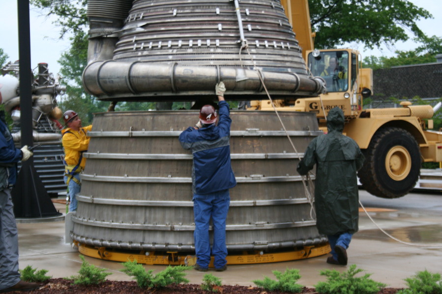 Placing F-1 rocket engine thrust chamber on nozzle extension during Installation of Building 4200 Engines (May 13, 2008) at Marshall Space Flight Center Engine Displays