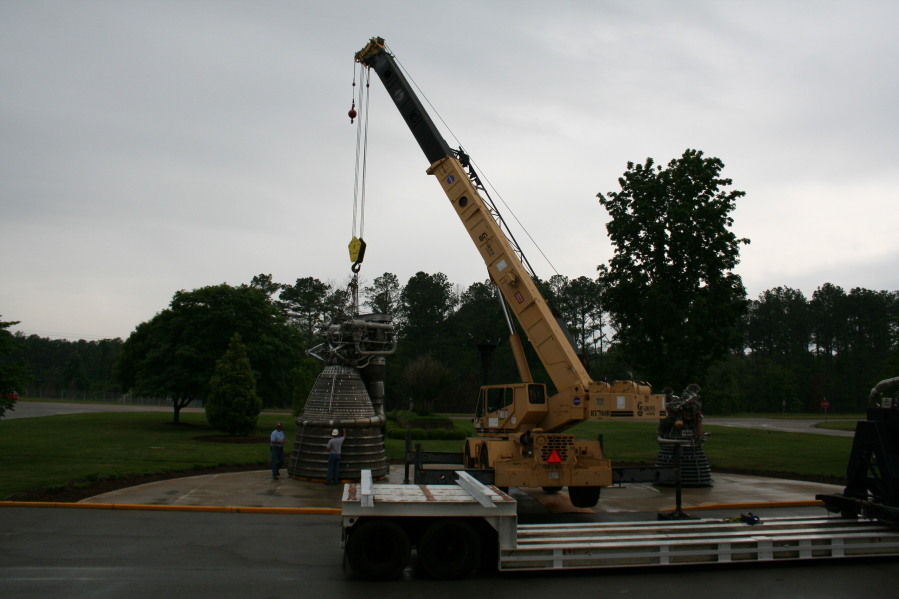 Placing F-1 rocket engine thrust chamber on nozzle extension during Installation of Building 4200 Engines (May 13, 2008) at Marshall Space Flight Center Engine Displays