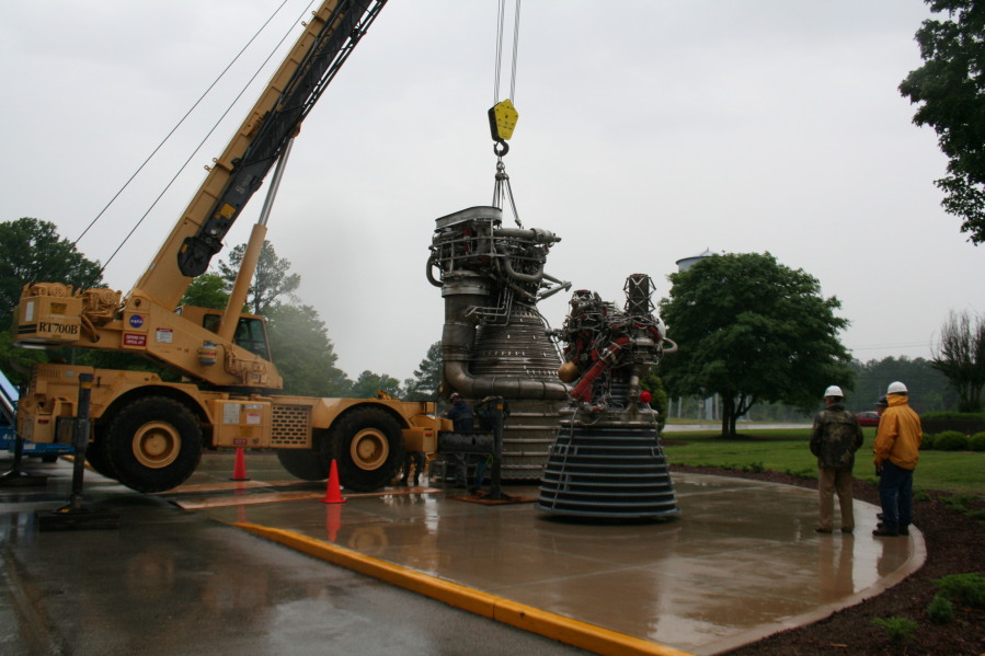 Placing F-1 rocket engine on throat support during Installation of Building 4200 Engines (May 13, 2008) at Marshall Space Flight Center Engine Displays