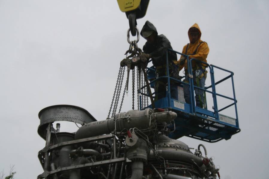 Removing crane hoist cable from F-1 rocket engine during Installation of Building 4200 Engines (May 13, 2008) at Marshall Space Flight Center Engine Displays