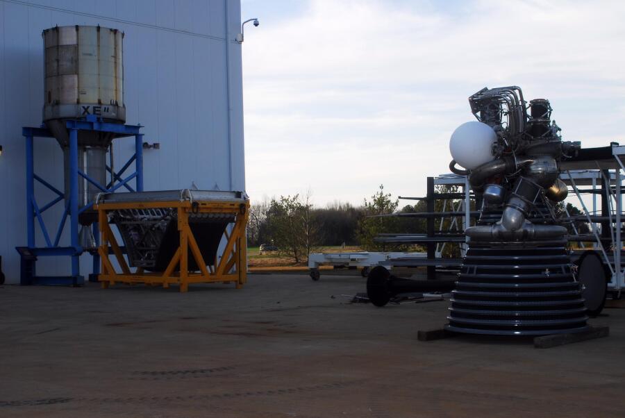 J-2 rocket engine, NERVA rocket engine, and XRS-2200 Linear Aerospike Engine at the north end of the lot behind Building 4205 during Building 4200 J-2 Engine Relocation (March 6, 2008) at Marshall Space Flight Center Engine Displays