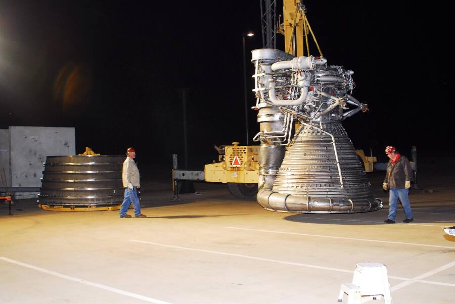 Lifting the F-1 rocket engine thrust chamber onto the nozzle extension during F-5036 Fit Test (March 6, 2008) at Marshall Space Flight Center Engine Displays