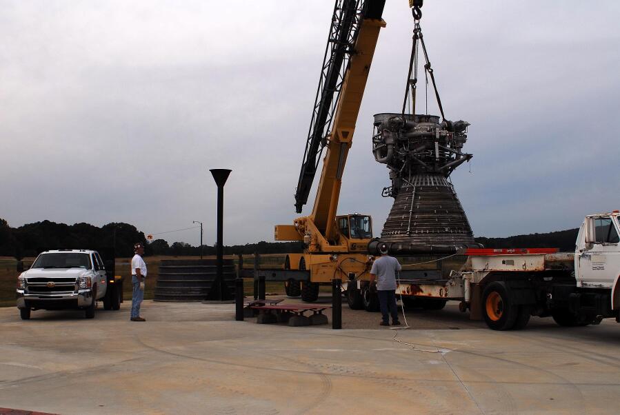 Placing the F-1 thrust chamber on the nozzle extension during F-4023 Installation at Building 4205 (October 21, 2009) at Marshall Space Flight Center Engine Displays