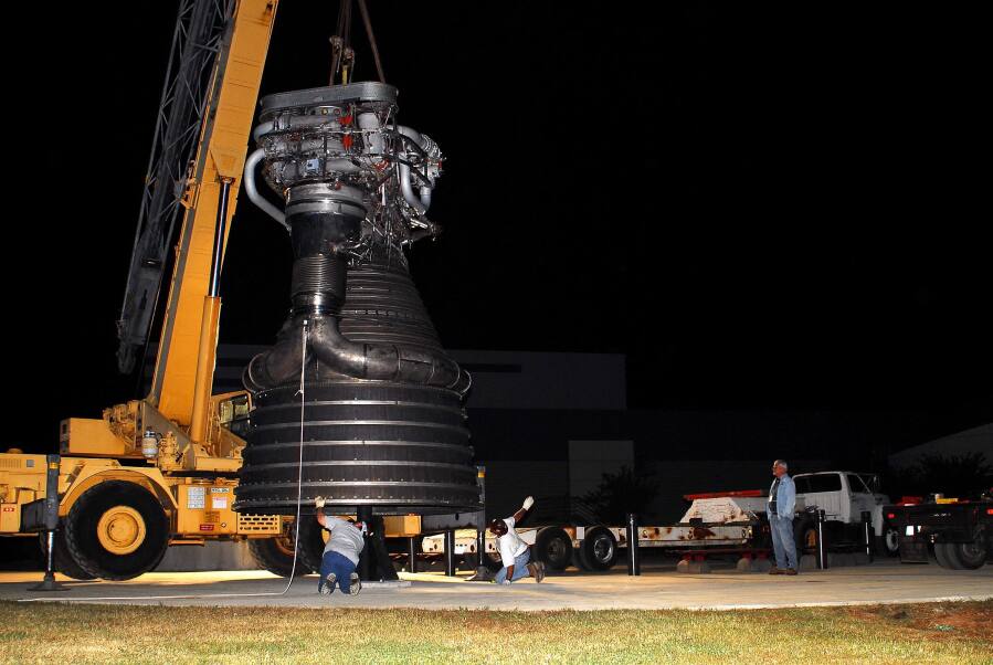 Lowering F-1 rocket engine onto throat support during F-4023 Installation at Building 4205 (October 21, 2009) at Marshall Space Flight Center Engine Displays