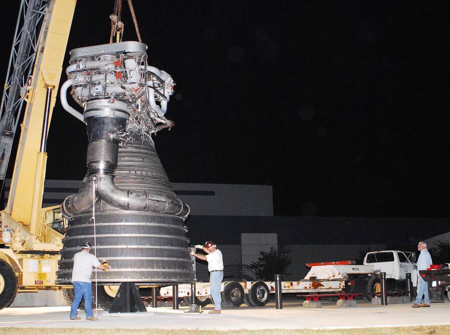 Lowering F-1 rocket engine onto throat support during F-4023 Installation at Building 4205 (October 21, 2009) at Marshall Space Flight Center Engine Displays