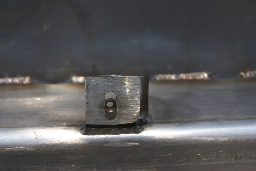 Thermal insulation tabs on the F-1 Nozzle Extension F-6045 hat bands at Marshall Space Flight Center