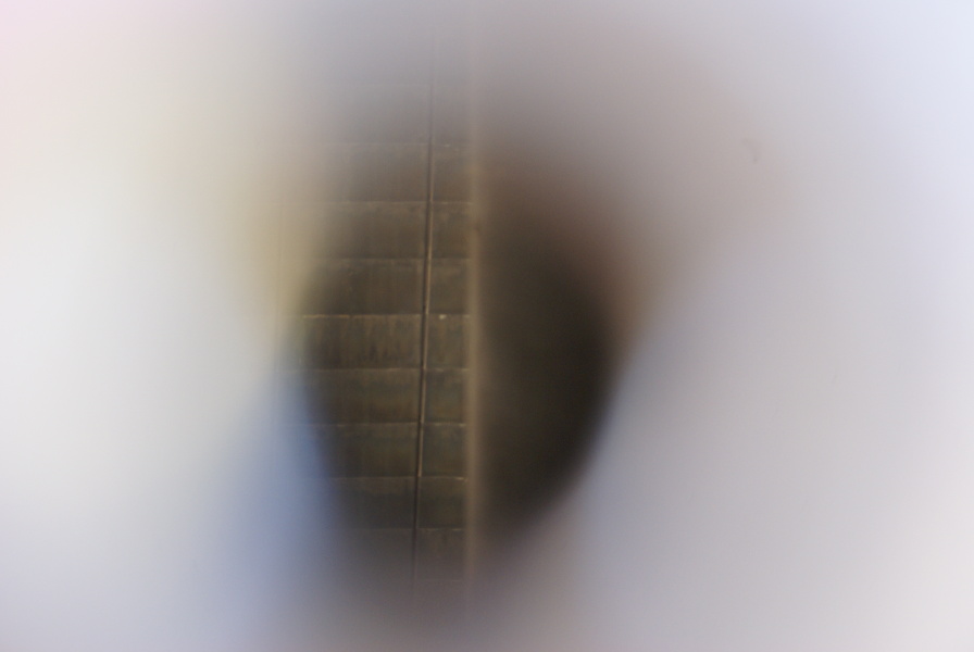 View into F-1 Engine F-4023 nozzle extension pyrotechnic igniter bosses at Marshall Space Flight Center, showing singles on nozzle extension wall and engine throat support