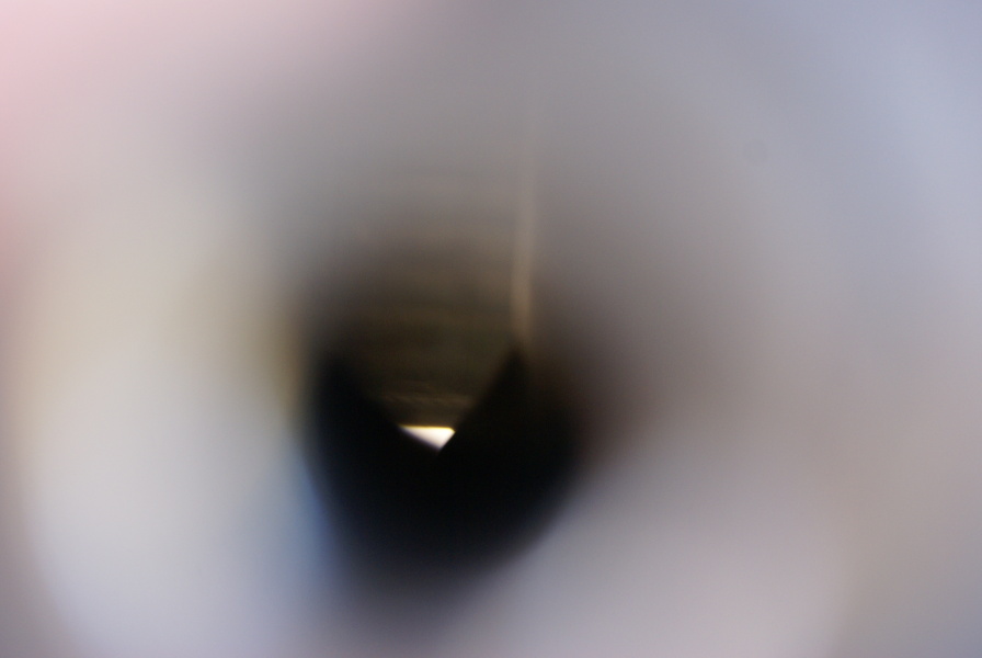 View into F-1 Engine F-4023 nozzle extension pyrotechnic igniter bosses at Marshall Space Flight Center, showing singles on nozzle extension wall and engine throat support