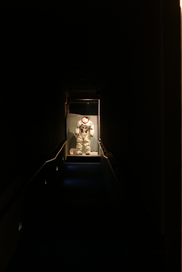 Armstrong's Apollo 11 Backup Suit at the end of a long, dark hallway at Neil Armstrong Air & Space
